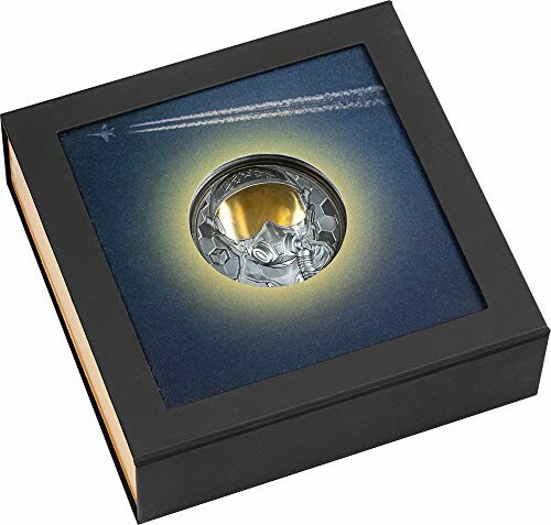 Silver coin with astronaut design in a display box