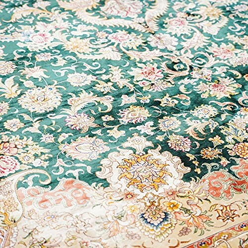 Intricate floral vintage rug with green and beige patterns.